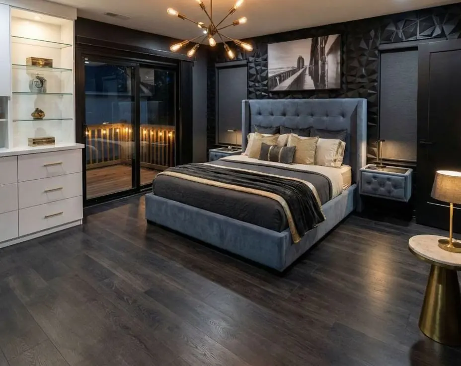 Primary bedroom remodel after, Bay Area: charcoal textured feature wall, built-in display cabinetry and dark hardwood floors