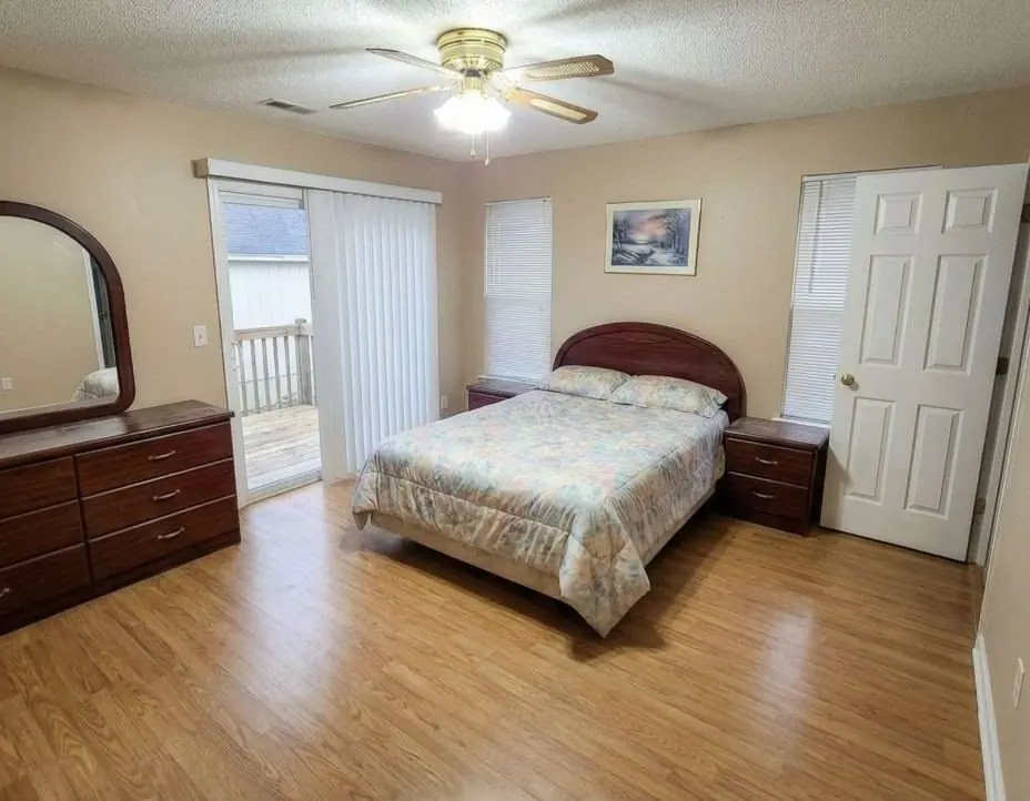 Primary bedroom before the remodel, a dated beige room